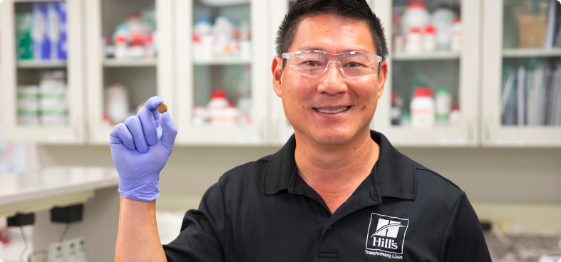 Hill's Pet Food Scientist holding pet food in a lab