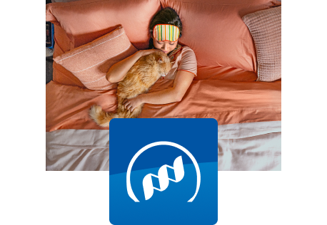 Macska pihen a gazdájával az ágyban